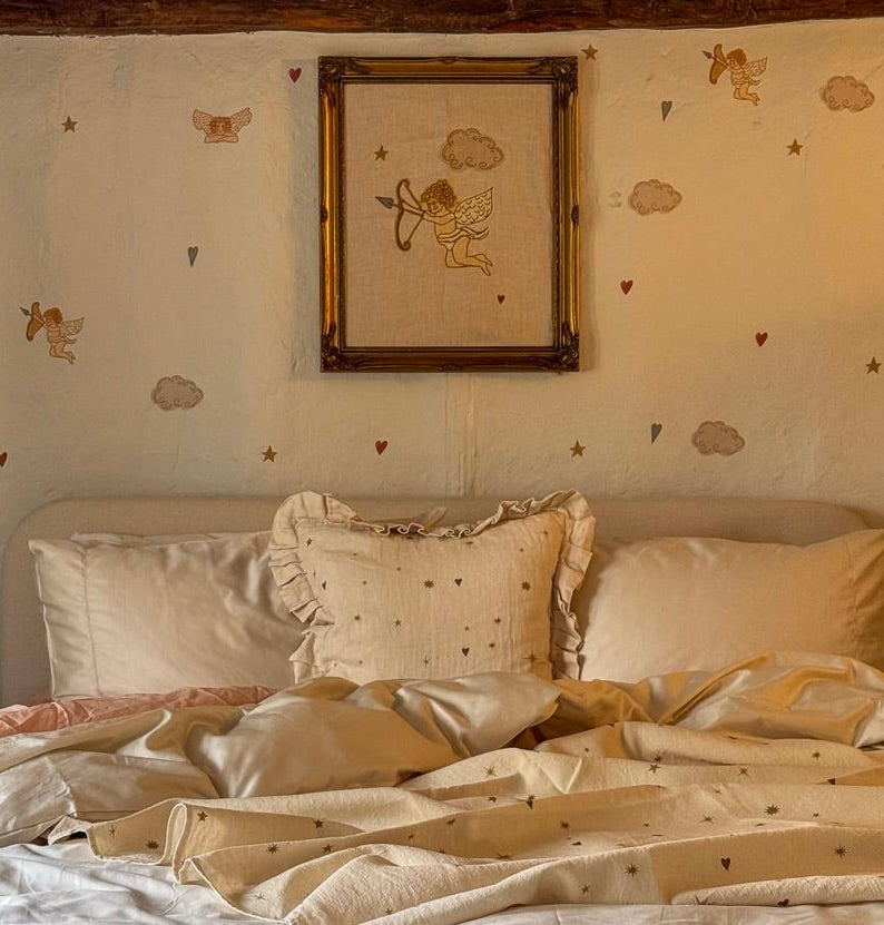 Cherub linen tea towel — lifestyle photo of the design in a bedroom setting